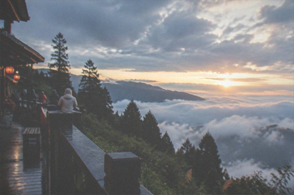 Sunrise light above a sea of clouds seen from a mountain viewpoint