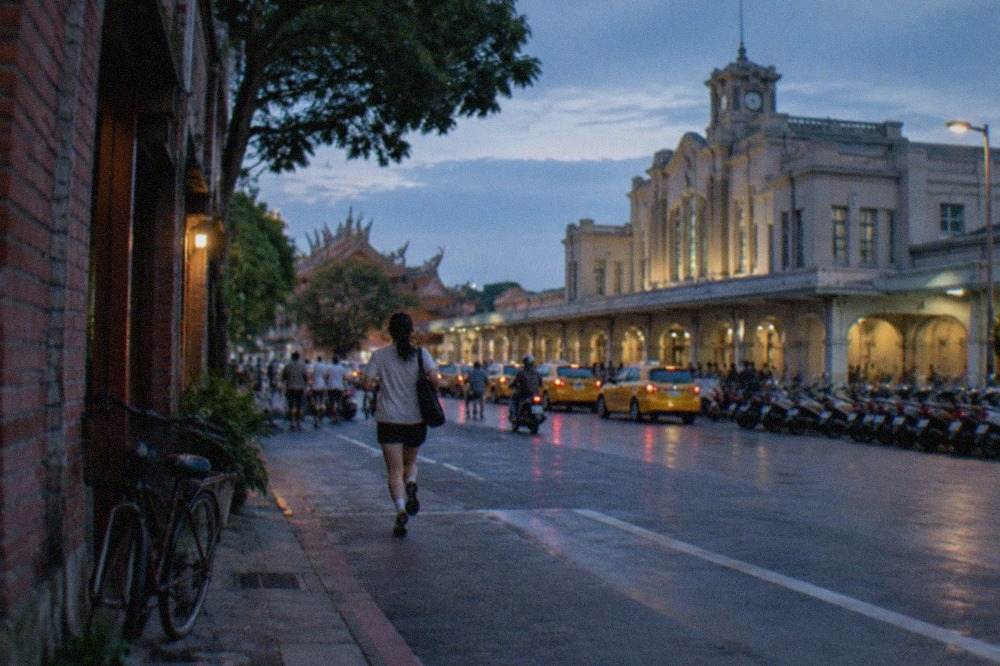 A bicycle parked on a quiet street beside old brick buildings in Tainan