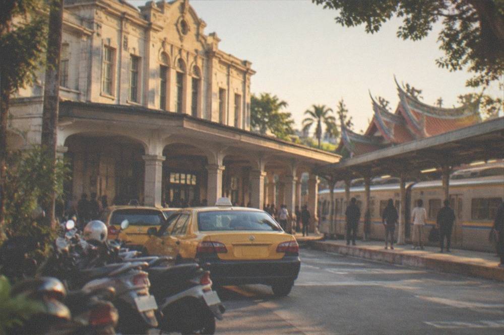 A conventional train at a city station platform with passengers waiting