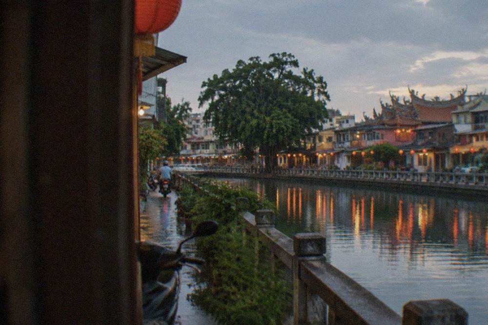 Glowing lanterns reflected in a harbor at night in a Taiwanese town