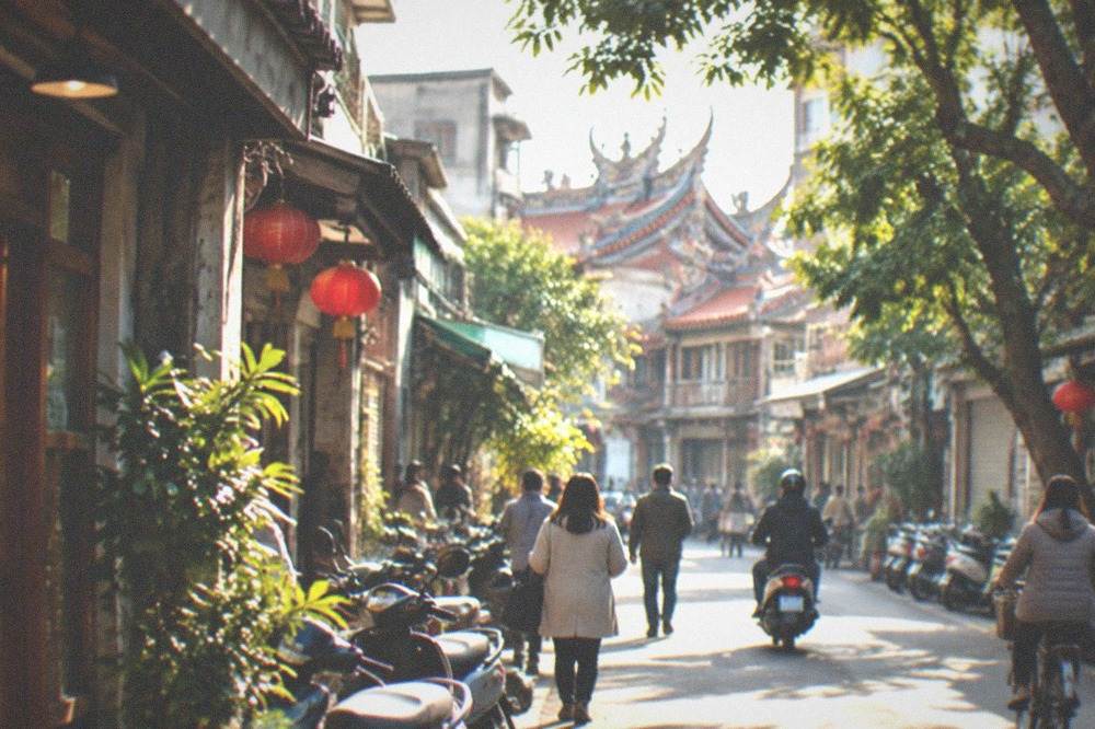 A mild winter evening street scene in Tainan with lit shopfronts and people in light coats