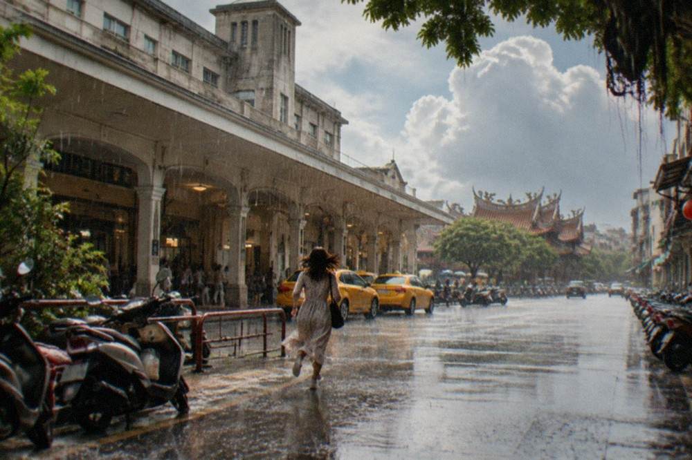 Heavy rain falling on an empty street in a Taiwanese old town, water streaming off tiled roofs