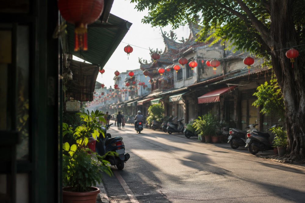 Strings of red lanterns hanging over an old street at night