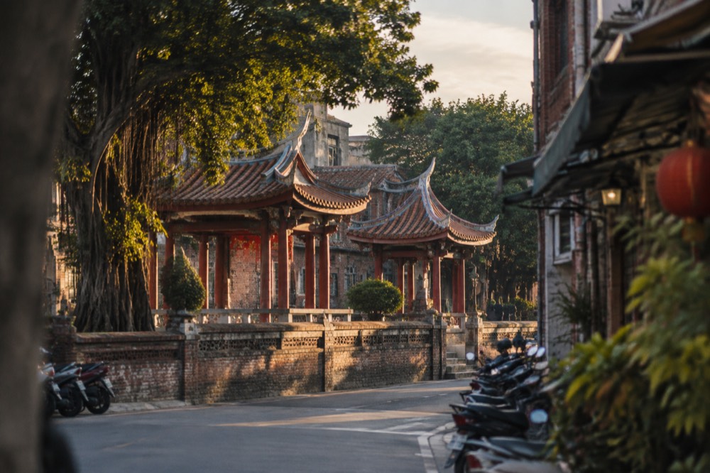 Historic brick buildings and a quiet street in Tainan's old city at golden hour