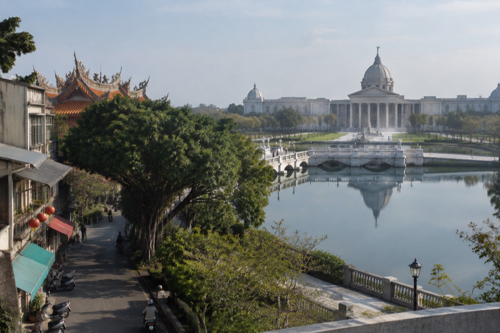 The classical facade of the Chimei Museum reflected in the pond in front of it