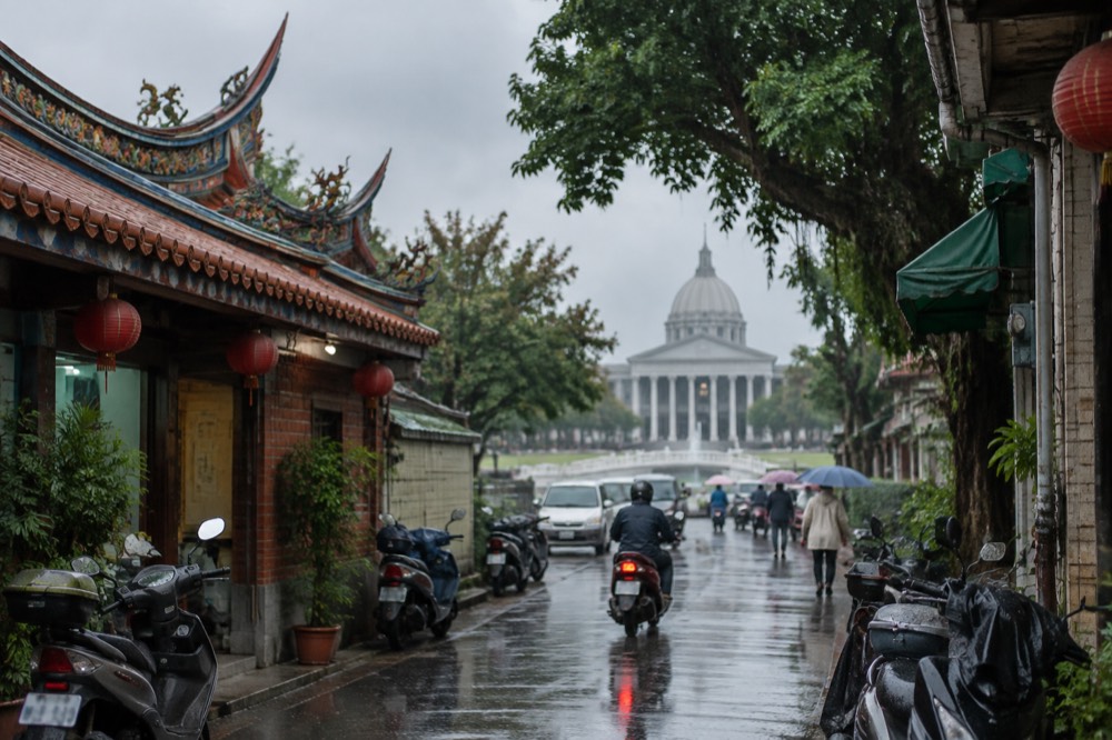 Rain falling on the tiled roofs and street of an old Tainan neighborhood