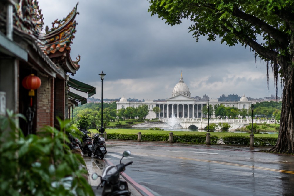 Dark rain clouds gathering over Tainan's city skyline on a warm afternoon