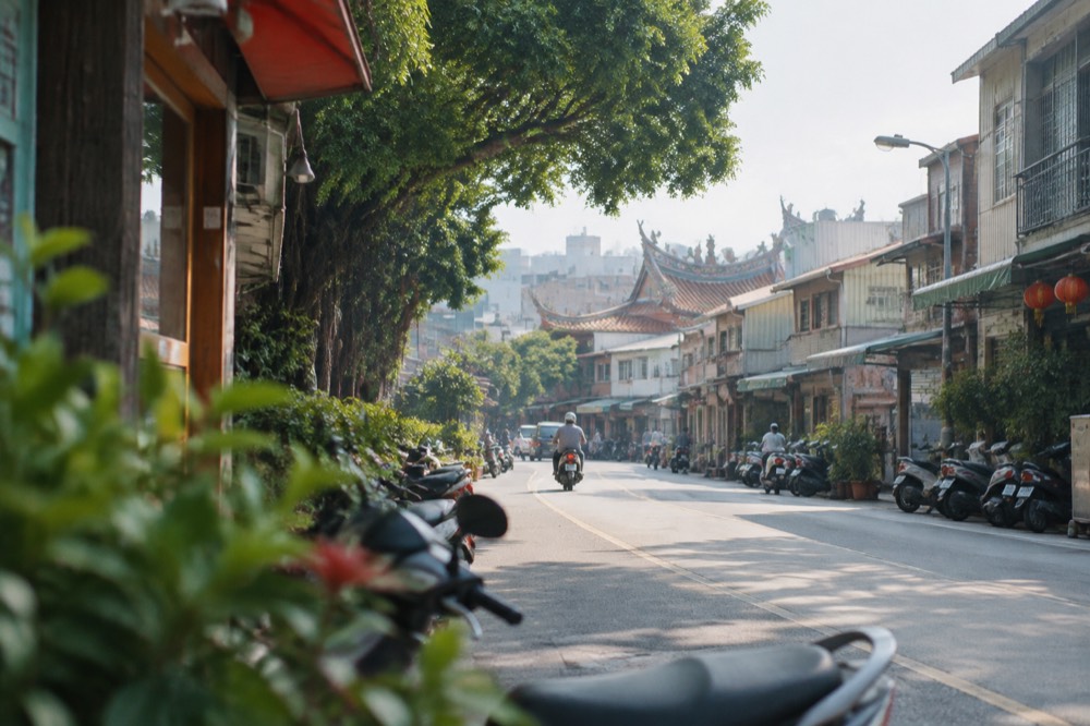 A wide sunny view over Tainan's rooftops with temple roofs and modern towers in the distance