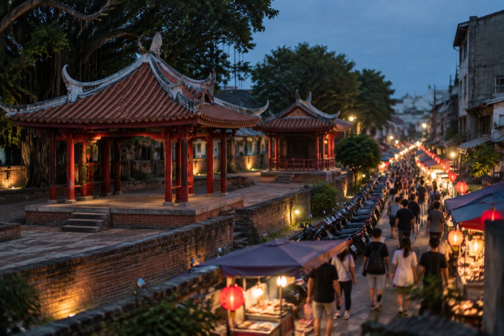 Lantern-lit stalls and crowds at a Tainan night market after dark