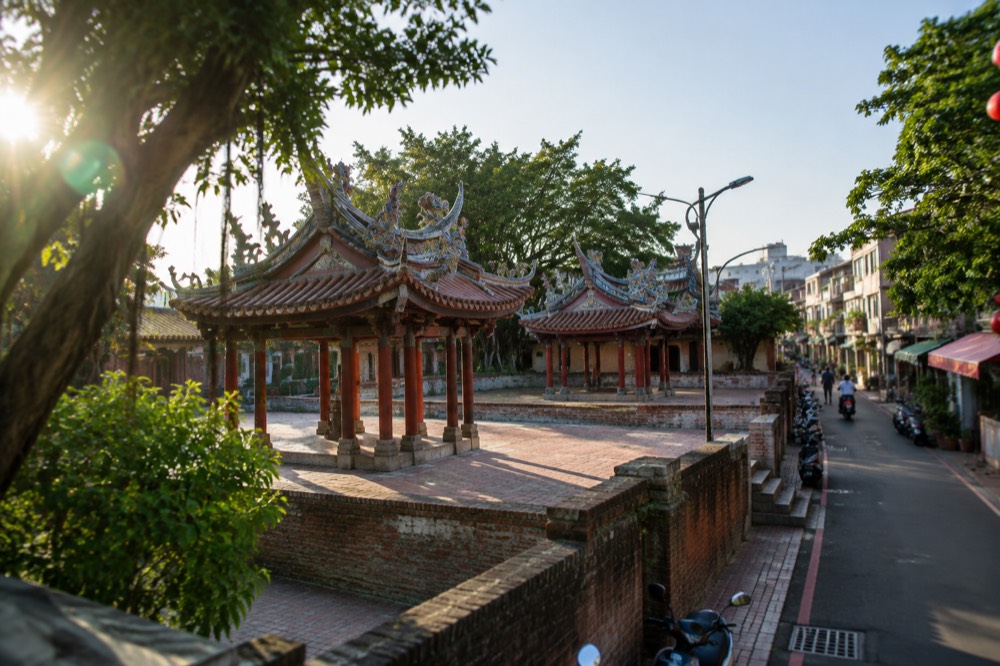 Ornate temple roof decorations with dragons under a clear blue sky