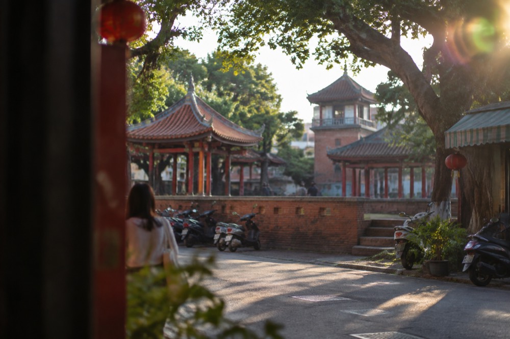 A red-brick Dutch-era tower with Chinese pavilion roofs surrounded by trees in central Tainan